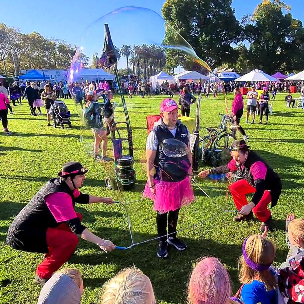 Bubble Brothers performing bubble show with person in a bubble.