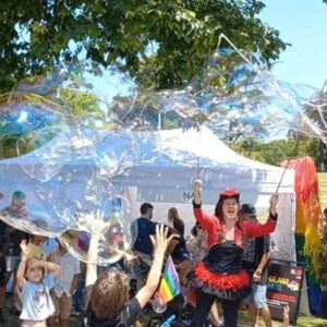 Bubble sisters making giant bubble for kids.