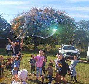 Bubble Sisters doing bubble show making giant bubbles.